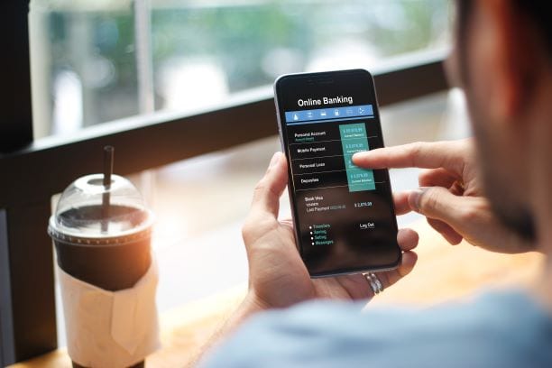 Person using mobile phone for online banking and frictionless digital onboarding