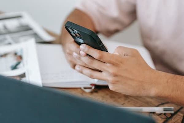 Person texting on a mobile phone to prevent sim swap fraud