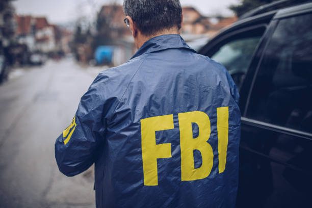 Man wearing FBI jacket investigating sim swap attacks