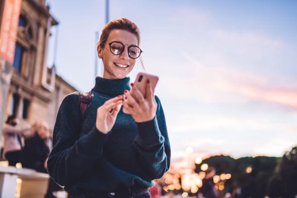 Woman smiling holding phone