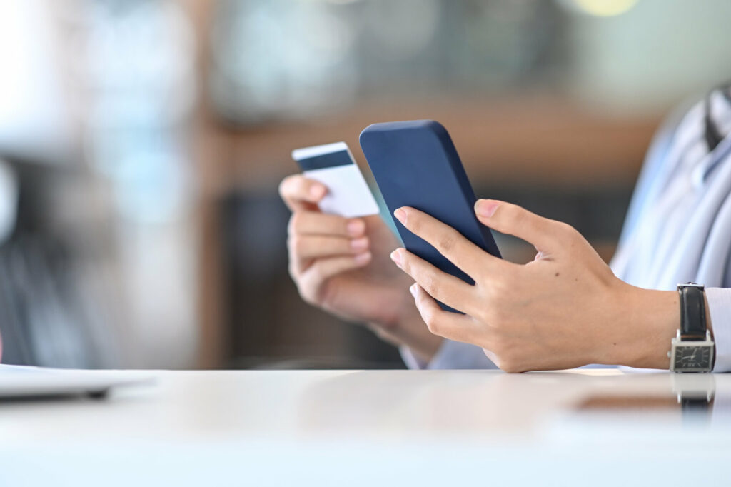 Person Holding Phone and Bank Card